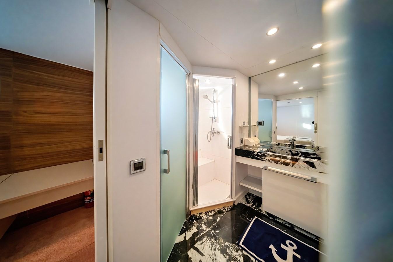 a bathroom with a large mirror aboard CUSTOM MADE MOTORSAILER Yacht for Sale