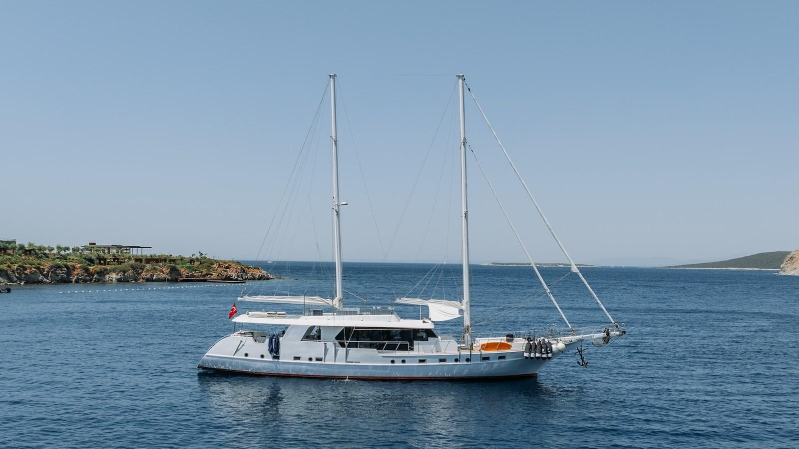 a white boat on the water aboard CUSTOM MADE MOTORSAILER Yacht for Sale