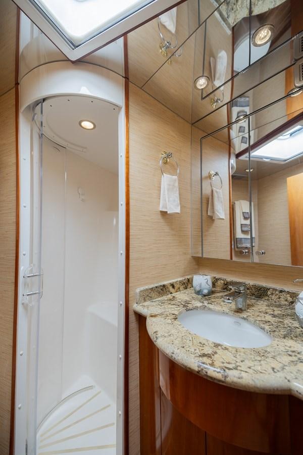 a bathroom with a sink and a mirror aboard TEMPTATION Yacht for Sale