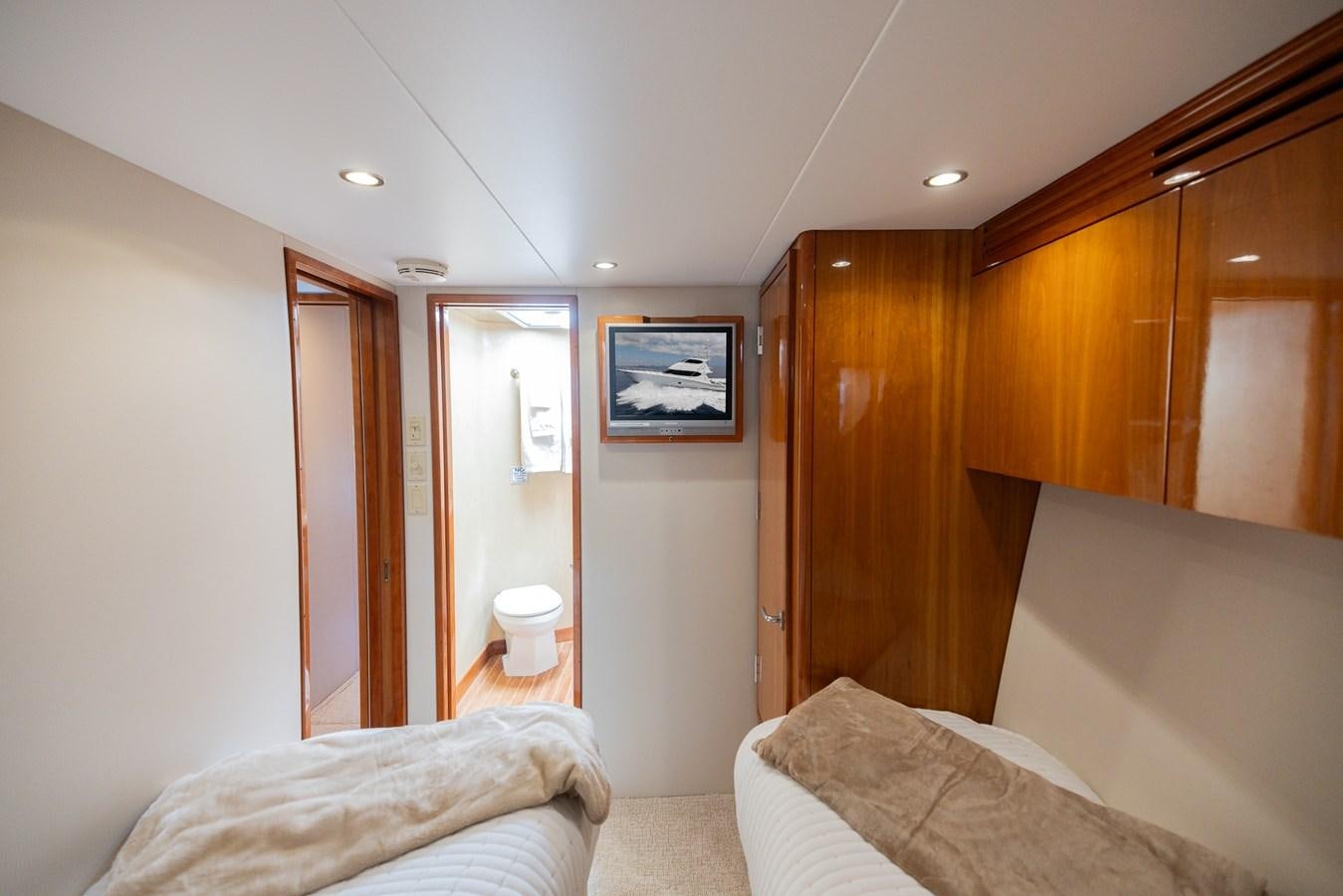 a bedroom with a bed and a closet aboard TEMPTATION Yacht for Sale