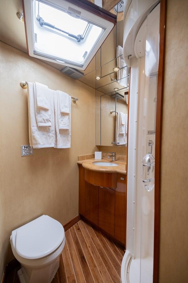 a bathroom with a sink and toilet aboard TEMPTATION Yacht for Sale