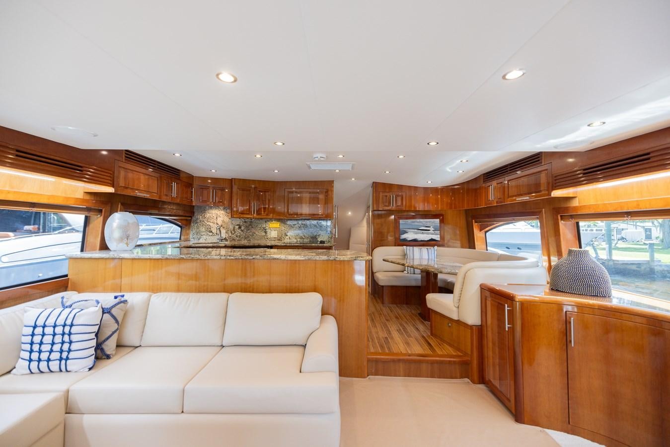 a living room with a large window aboard TEMPTATION Yacht for Sale