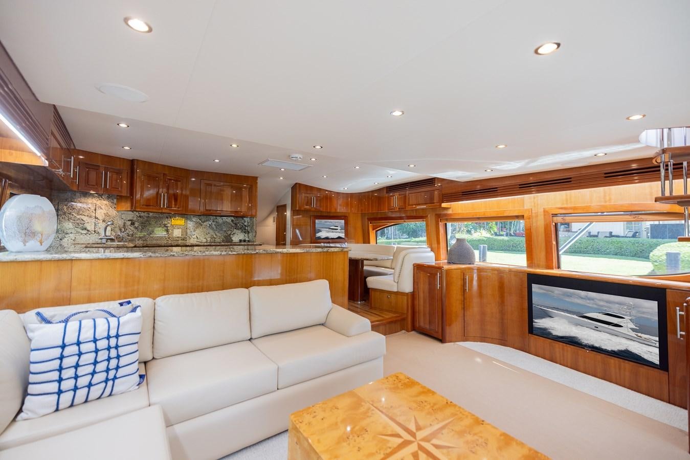 a living room with a large fireplace aboard TEMPTATION Yacht for Sale