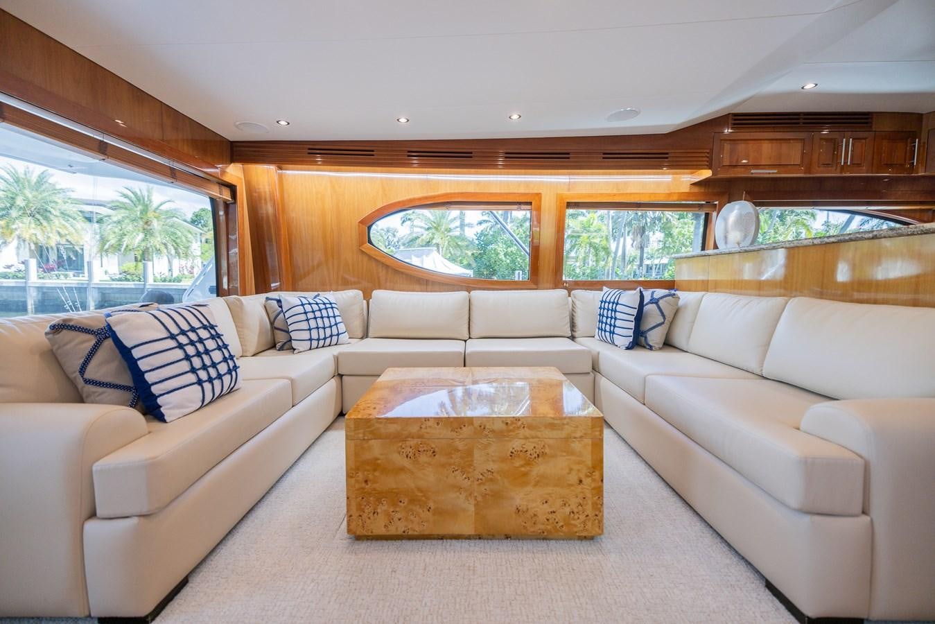 a living room with a couch and a coffee table aboard TEMPTATION Yacht for Sale