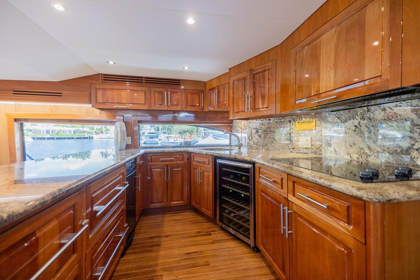 a kitchen with wooden cabinets aboard TEMPTATION Yacht for Sale