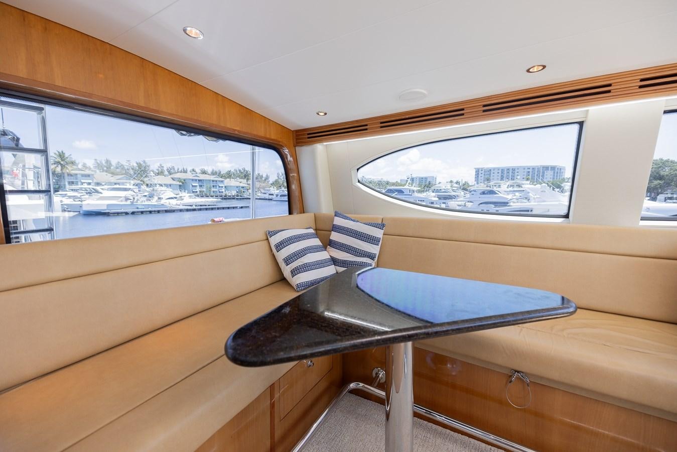 a room with a bed and a window aboard TEMPTATION Yacht for Sale