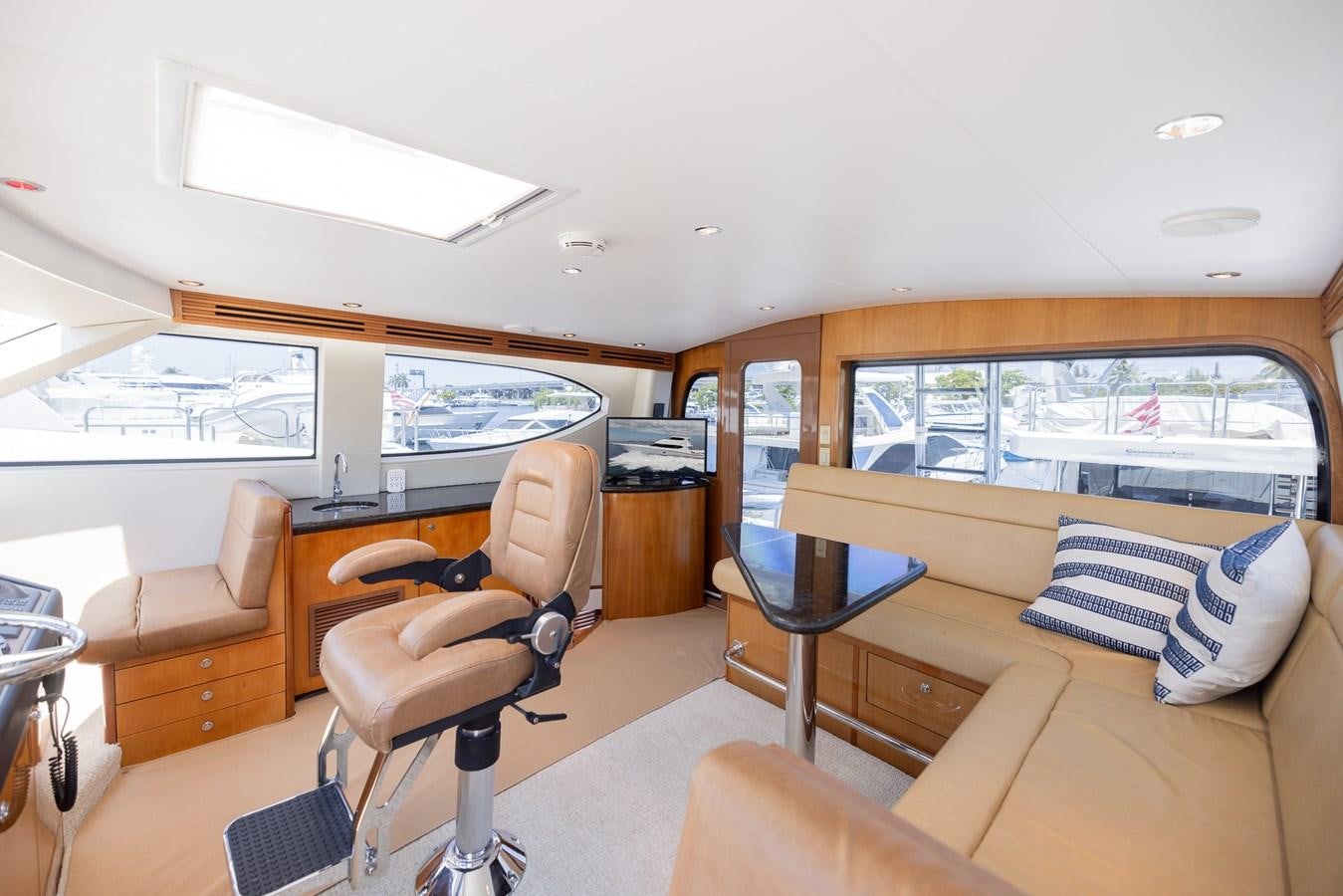 a living room with a large window aboard TEMPTATION Yacht for Sale