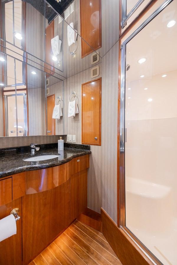 a bathroom with a sink and a mirror aboard TEMPTATION Yacht for Sale