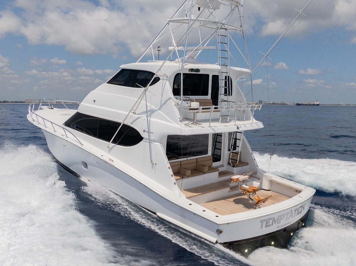 a white boat on the water aboard TEMPTATION Yacht for Sale