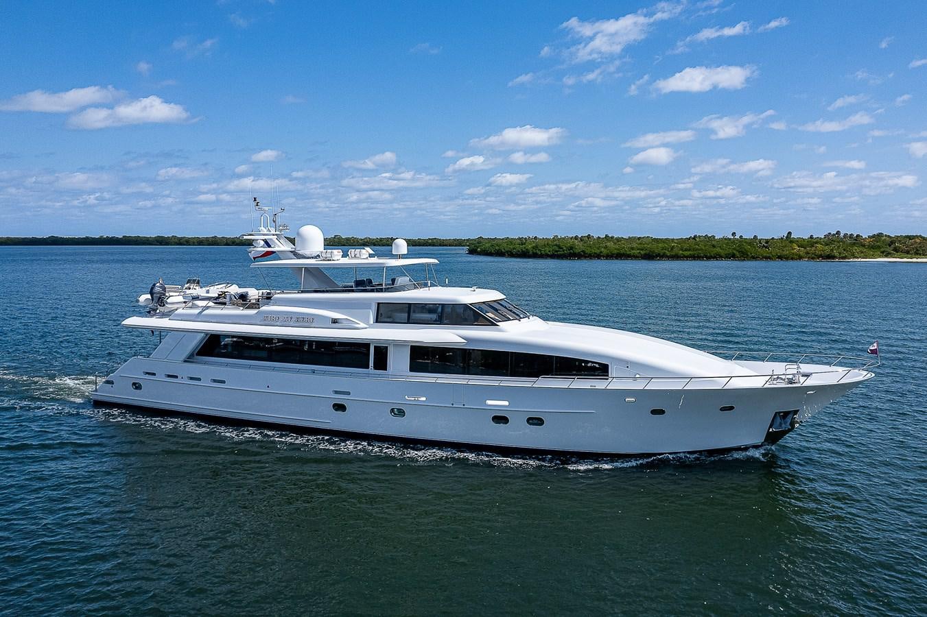 a white yacht on the water aboard WIRE WE HERE Yacht for Sale