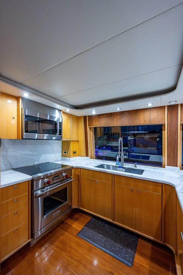 a kitchen with wooden cabinets aboard WIRE WE HERE Yacht for Sale