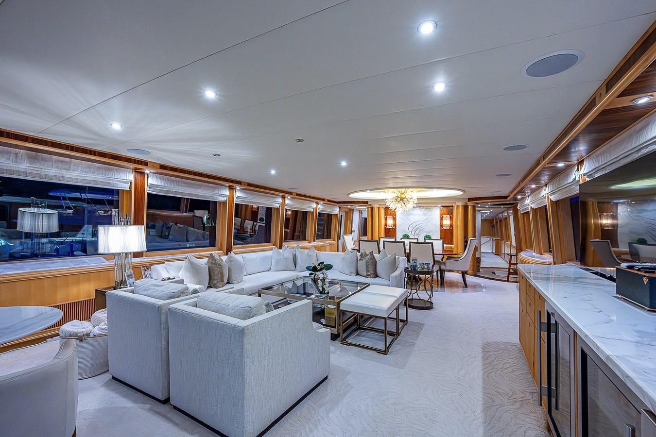 a large living room with a large white sofa and a large white table aboard WIRE WE HERE Yacht for Sale