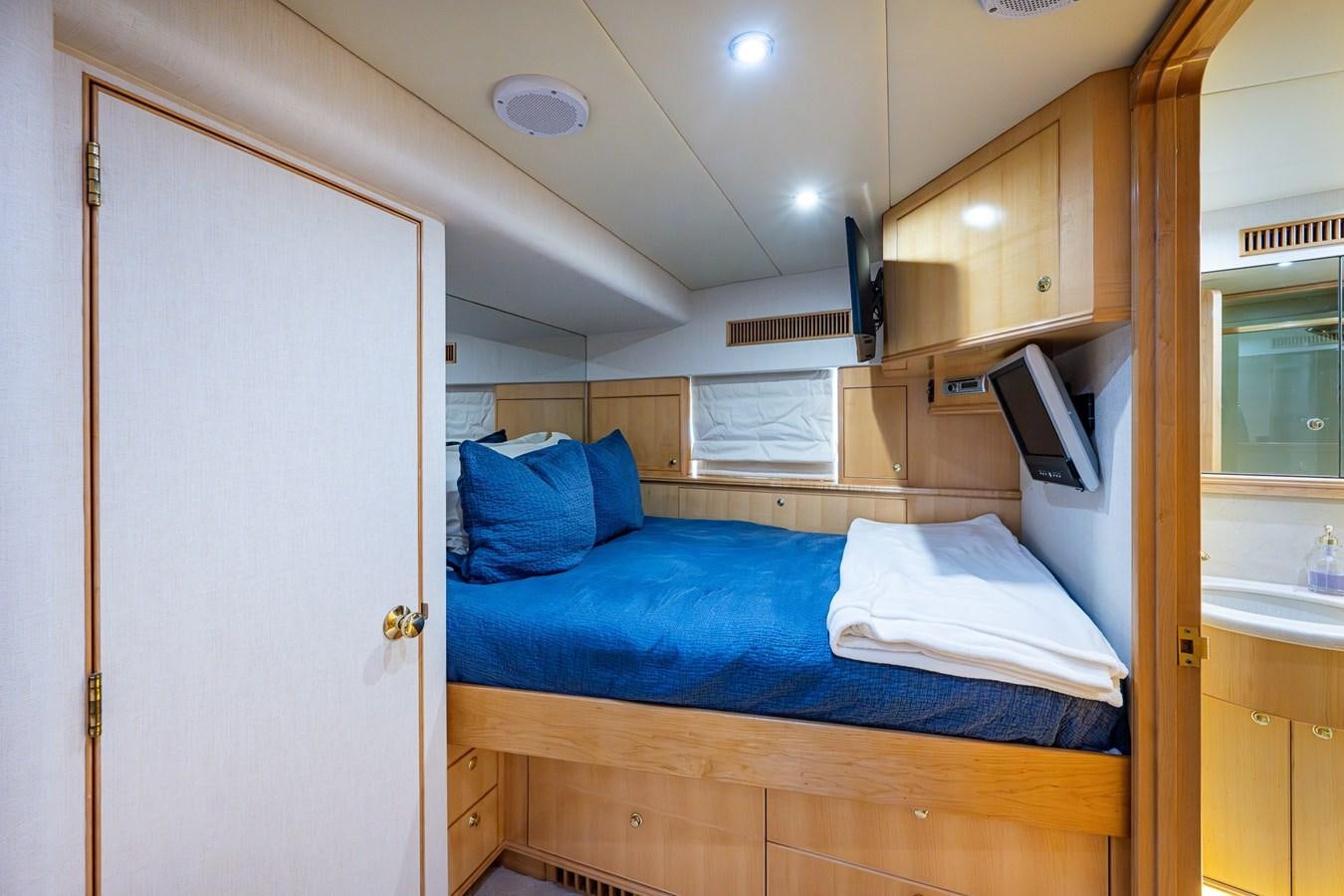 a bedroom with a bed and a desk aboard WIRE WE HERE Yacht for Sale