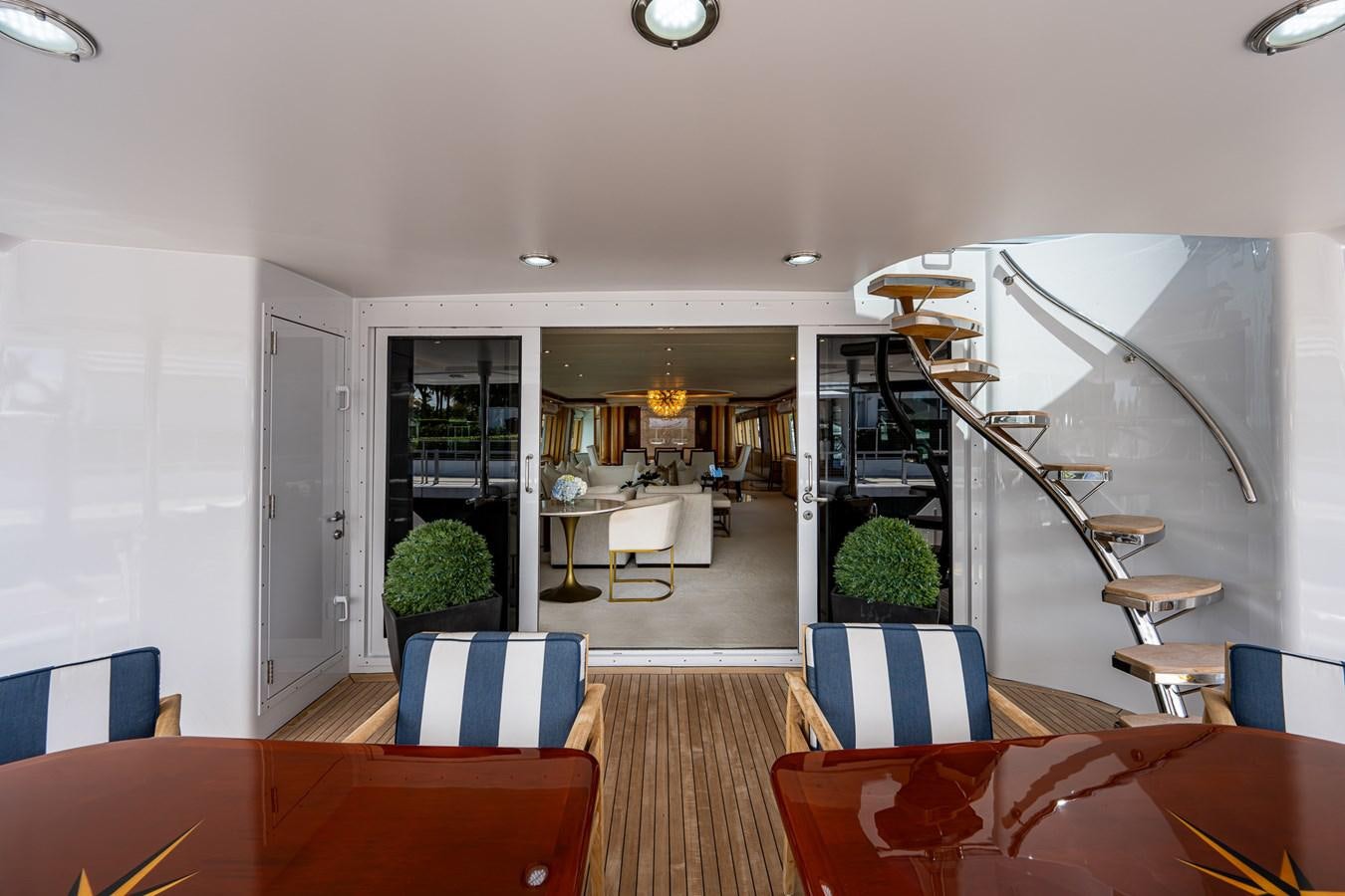 a room with a staircase and a table and chairs aboard WIRE WE HERE Yacht for Sale
