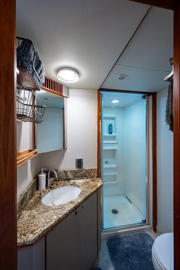 a bathroom with a sink and a shower aboard WIRE WE HERE Yacht for Sale