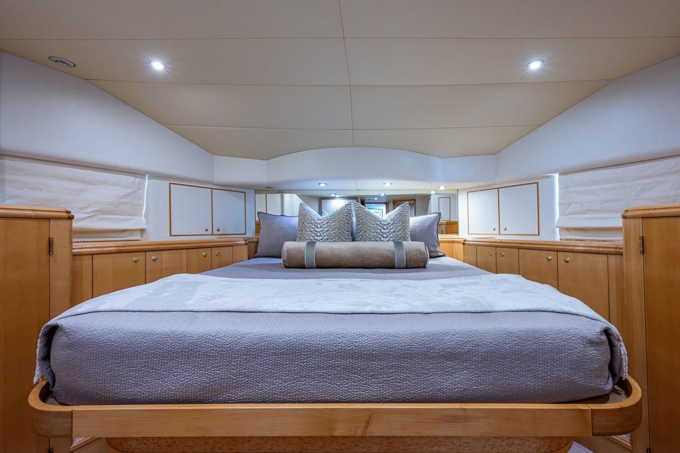 a bed with a blue comforter aboard WIRE WE HERE Yacht for Sale