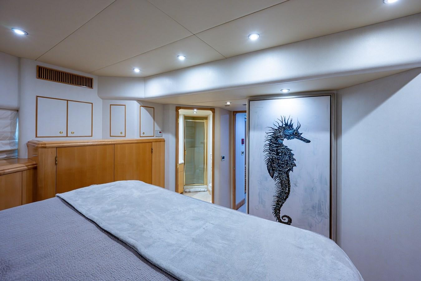 a bedroom with a large mirror aboard WIRE WE HERE Yacht for Sale