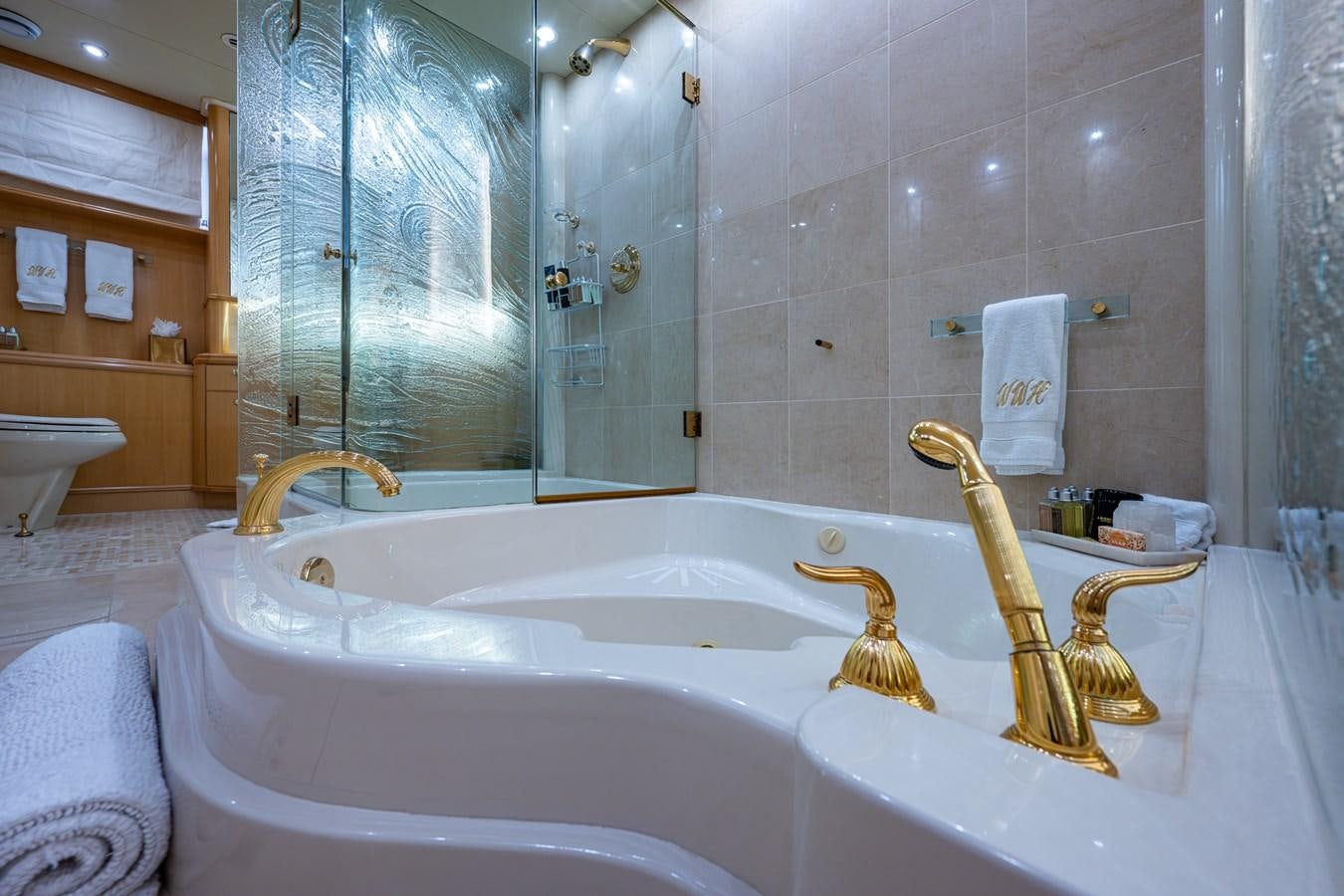 a bathroom with a bathtub and shower aboard WIRE WE HERE Yacht for Sale