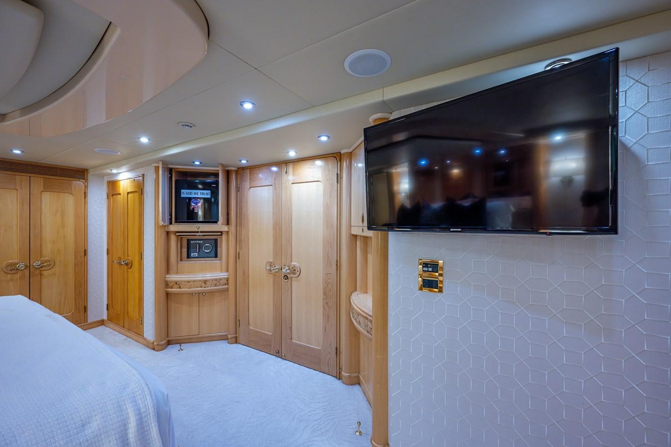 a bedroom with a bed and a television on the wall aboard WIRE WE HERE Yacht for Sale