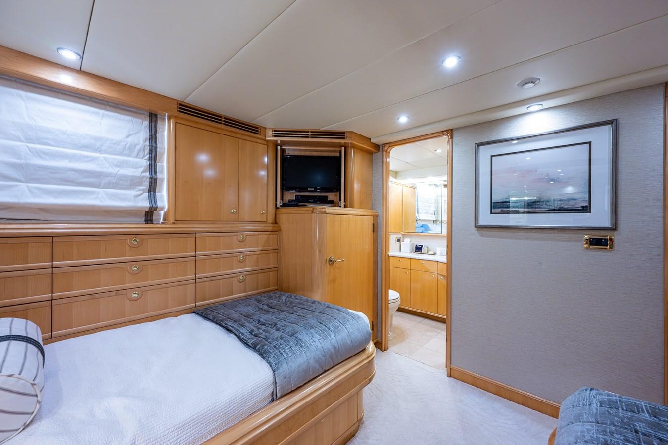 a bedroom with a bed and a television aboard WIRE WE HERE Yacht for Sale
