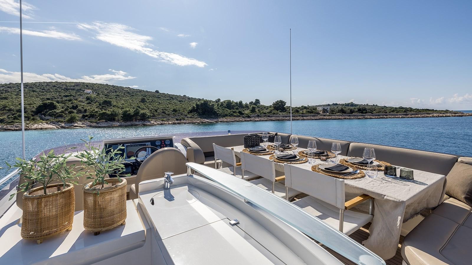 a large white table with chairs on it next to a body of water aboard SEA DREAM II Yacht for Sale