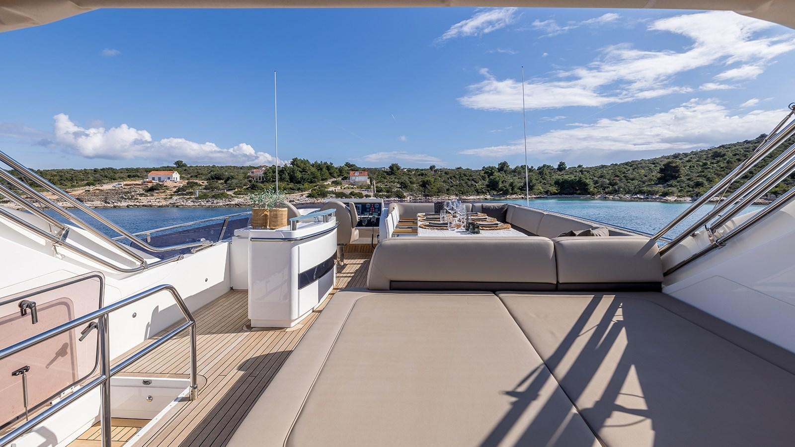 a deck with a boat and a dock with a body of water in the background aboard SEA DREAM II Yacht for Sale