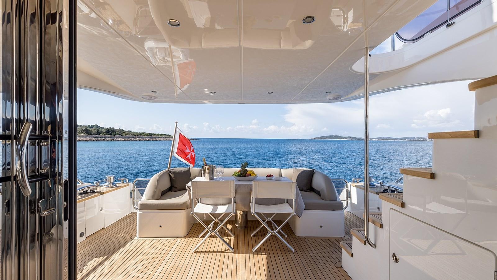a boat with a table and chairs on the deck aboard SEA DREAM II Yacht for Sale