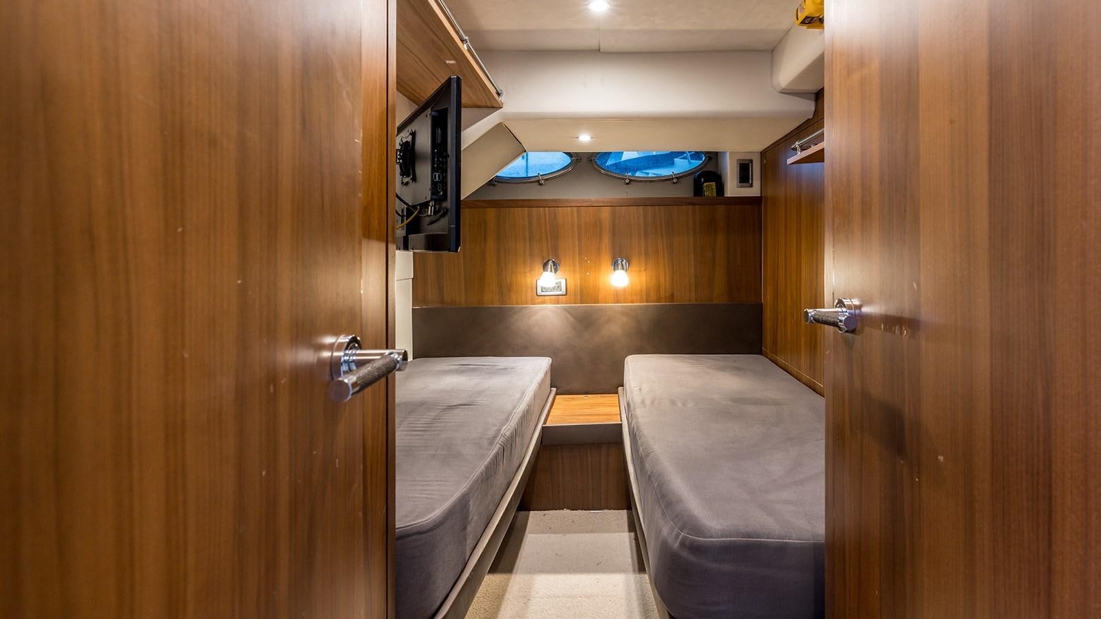 a bathroom with a tub and wooden cabinets aboard SEA DREAM II Yacht for Sale