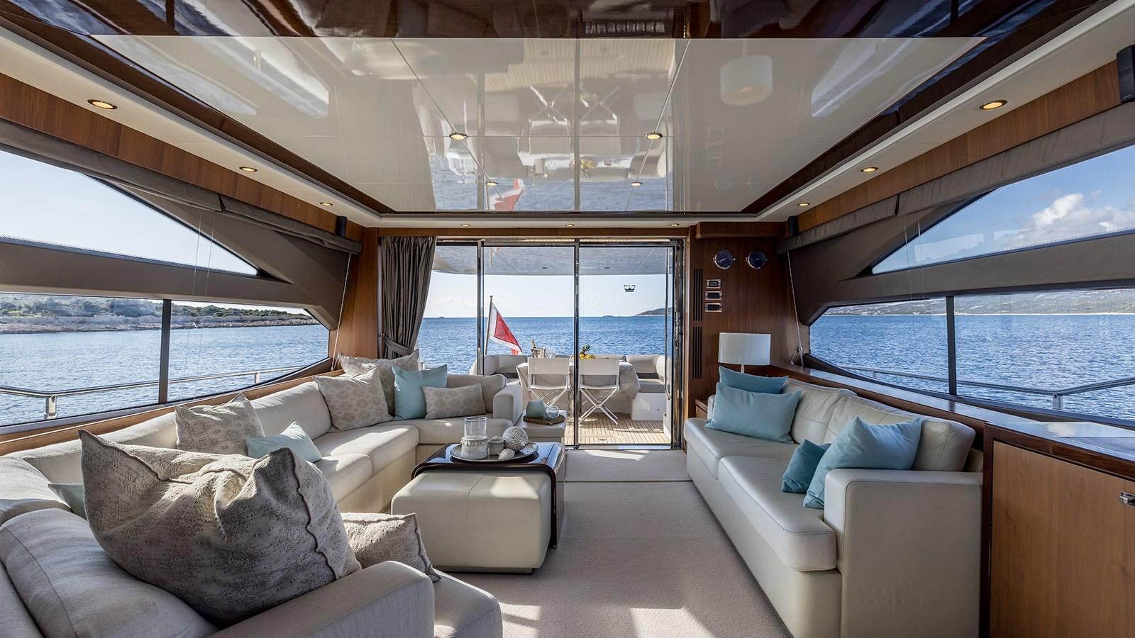 a room with a couch and a table and a window aboard SEA DREAM II Yacht for Sale