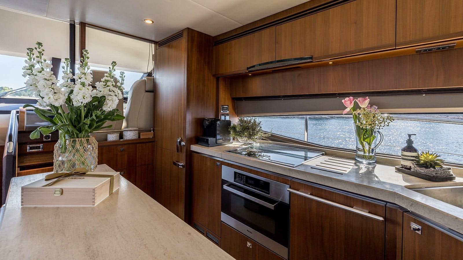 a kitchen with a vase of flowers aboard SEA DREAM II Yacht for Sale