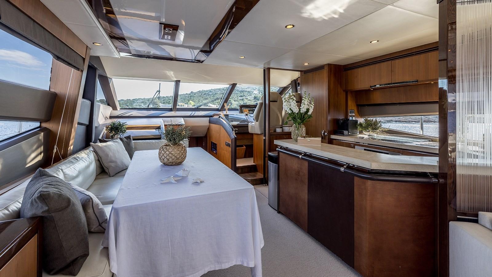 a room with a table and couch aboard SEA DREAM II Yacht for Sale