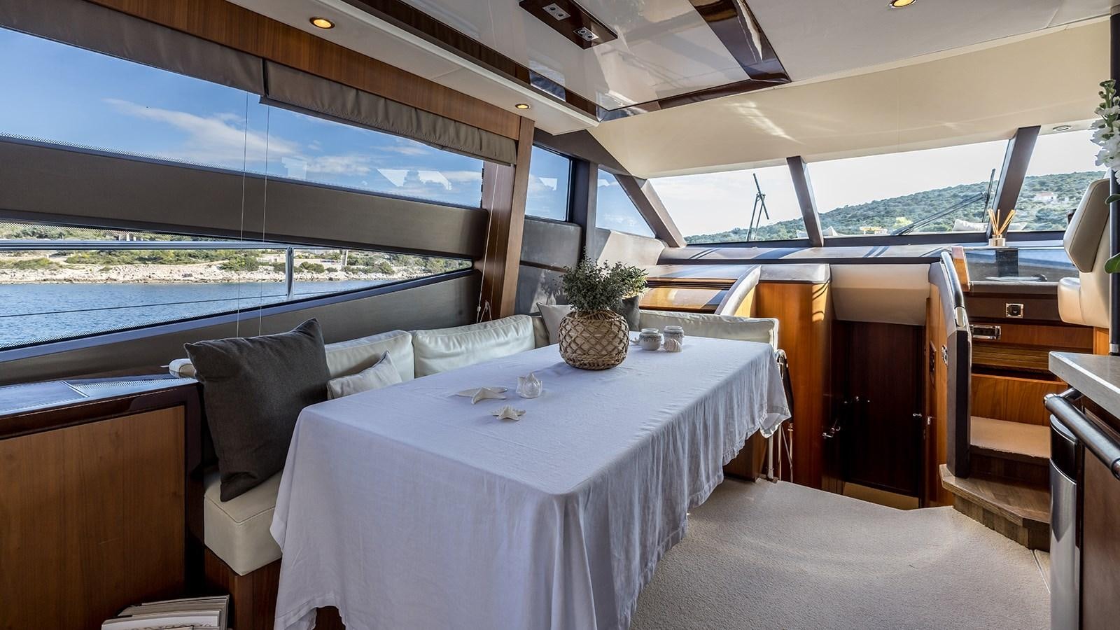 a room with a table and chairs aboard SEA DREAM II Yacht for Sale