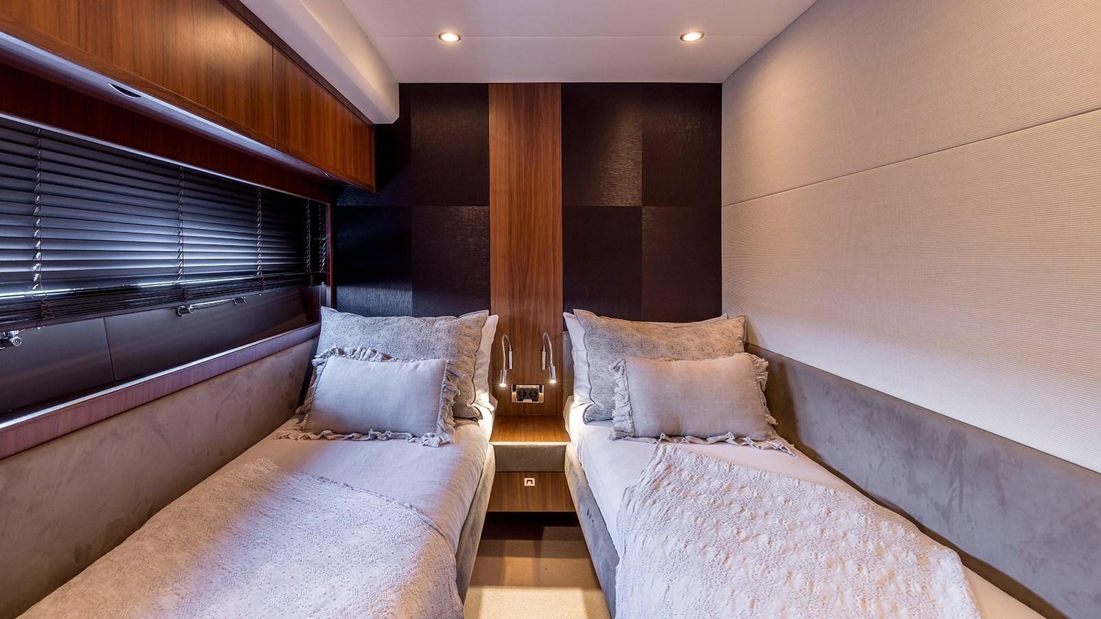 a room with a bed and a window aboard SEA DREAM II Yacht for Sale