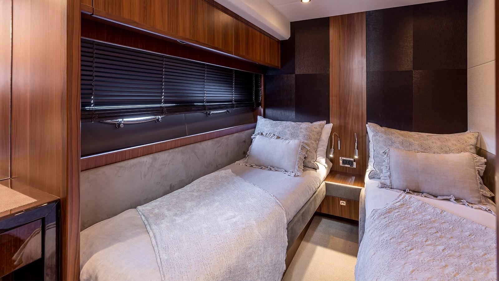 a room with a bed and a window aboard SEA DREAM II Yacht for Sale