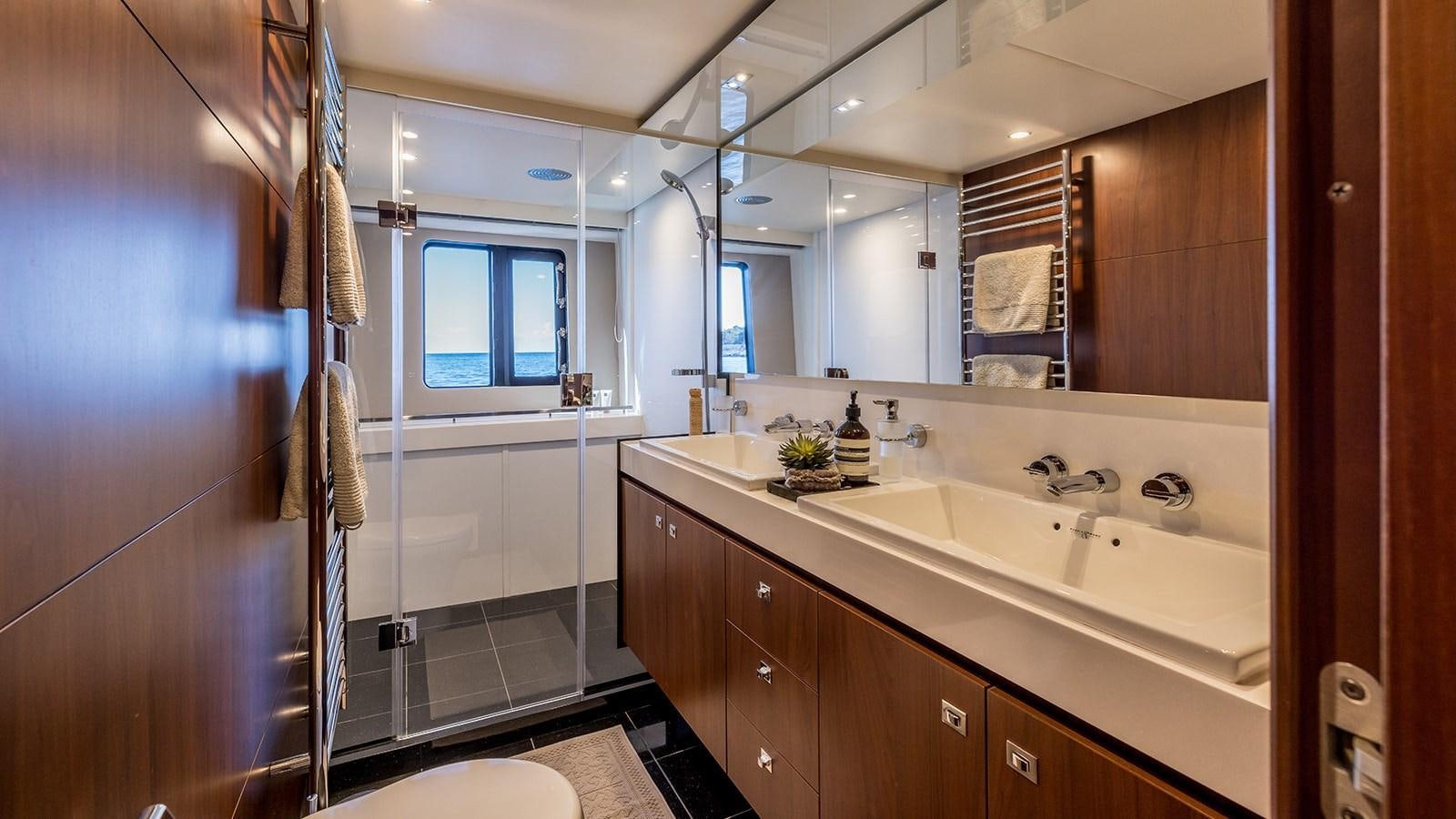 a bathroom with a large mirror aboard SEA DREAM II Yacht for Sale