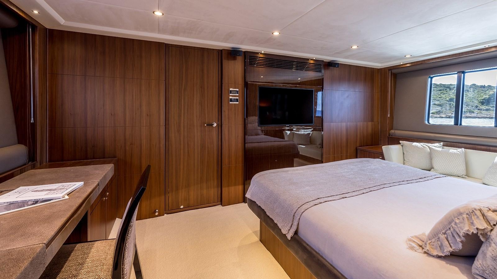 a room with a bed and a television aboard SEA DREAM II Yacht for Sale