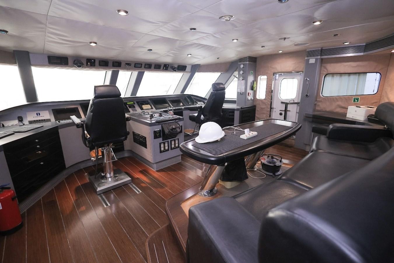 a room with a table and chairs aboard 2008 OCEANDRO 48M CUSTOM Yacht for Sale