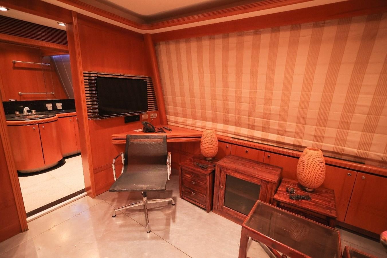 a room with a tv and a chair aboard 2008 OCEANDRO 48M CUSTOM Yacht for Sale