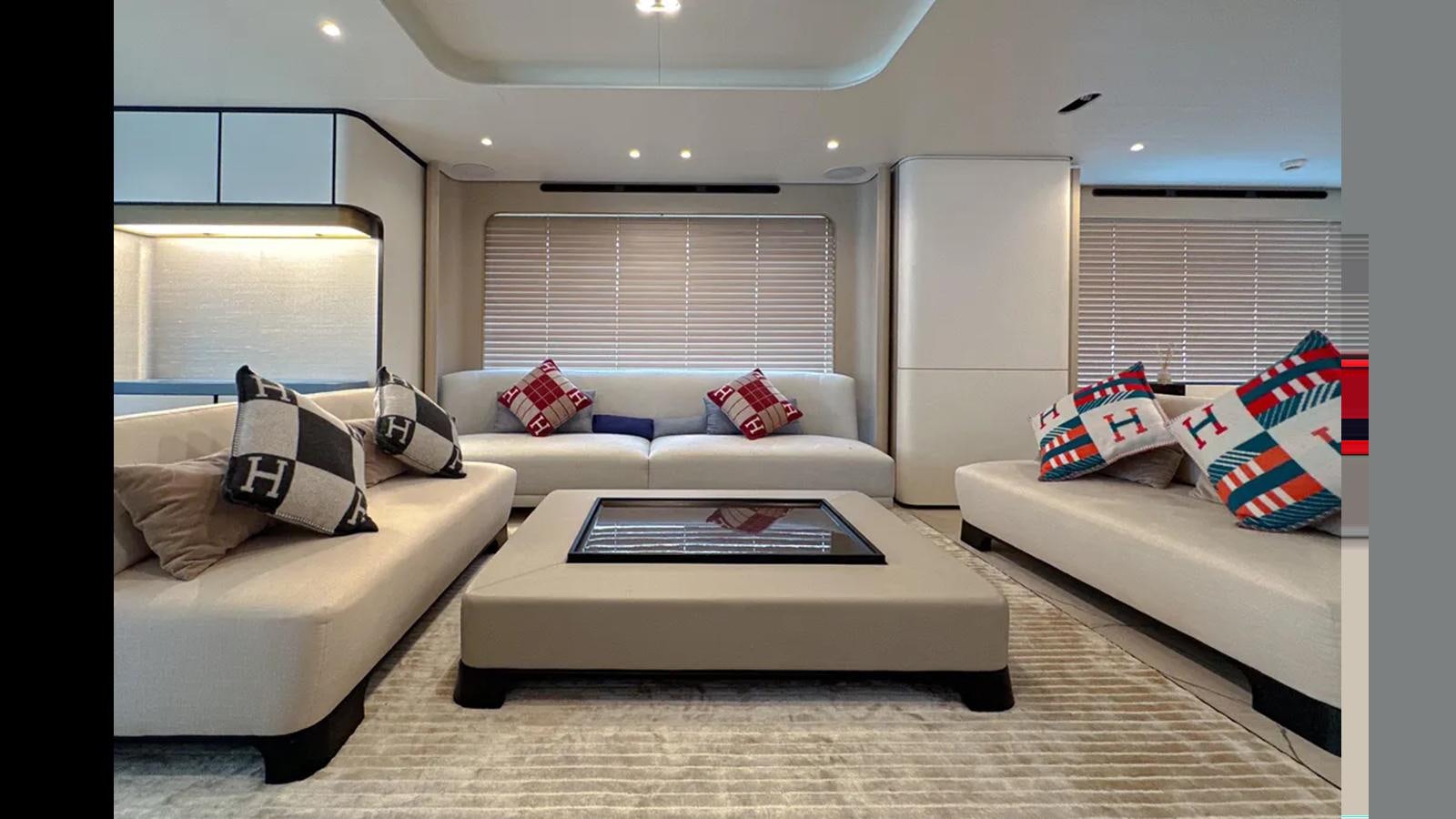 a living room with white couches and a coffee table aboard LONG TENG Yacht for Sale