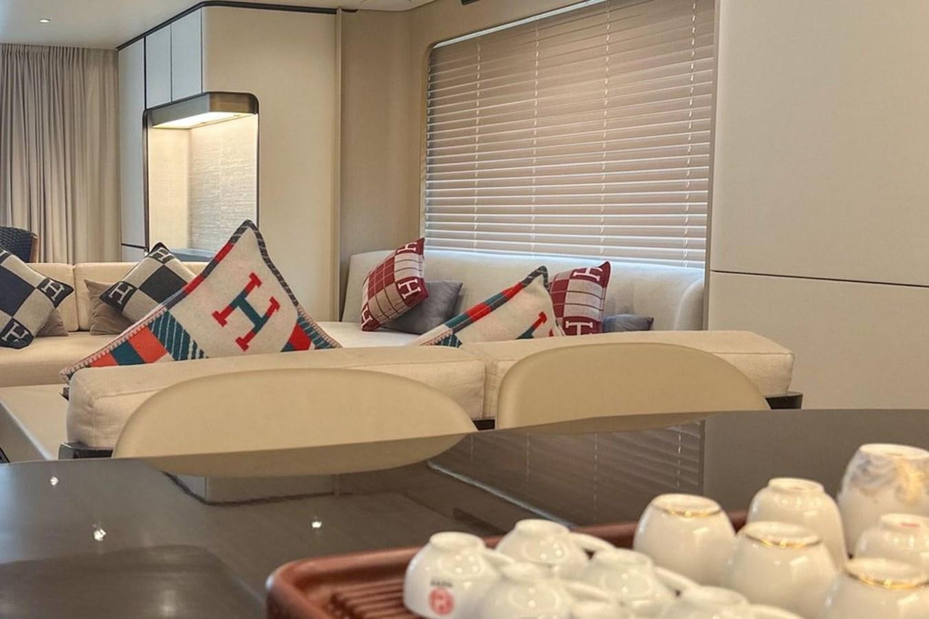 a room with a bed and a table with a chair aboard LONG TENG Yacht for Sale