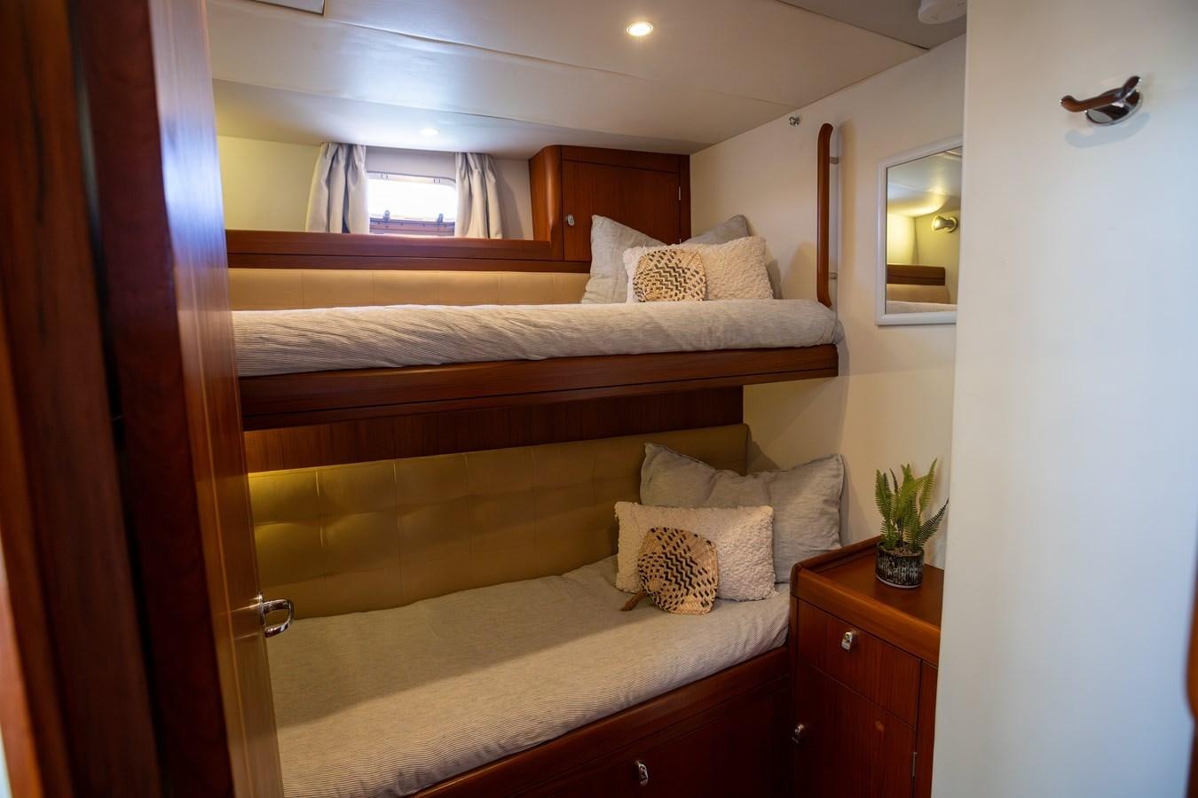 a bed with a wood headboard aboard CRAZY HORSE Yacht for Sale