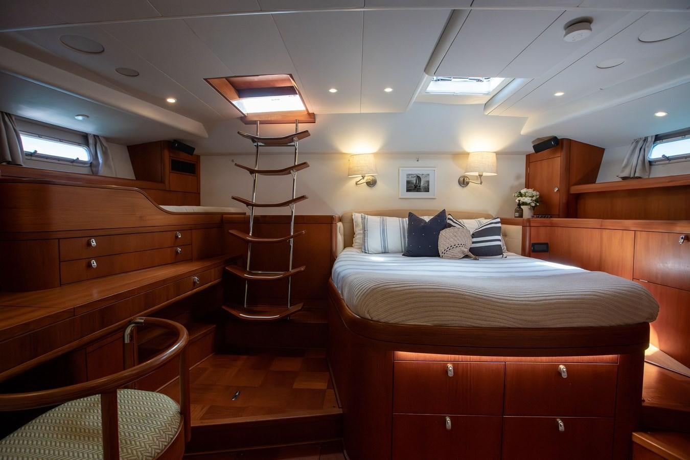 a bedroom with wooden furniture aboard CRAZY HORSE Yacht for Sale