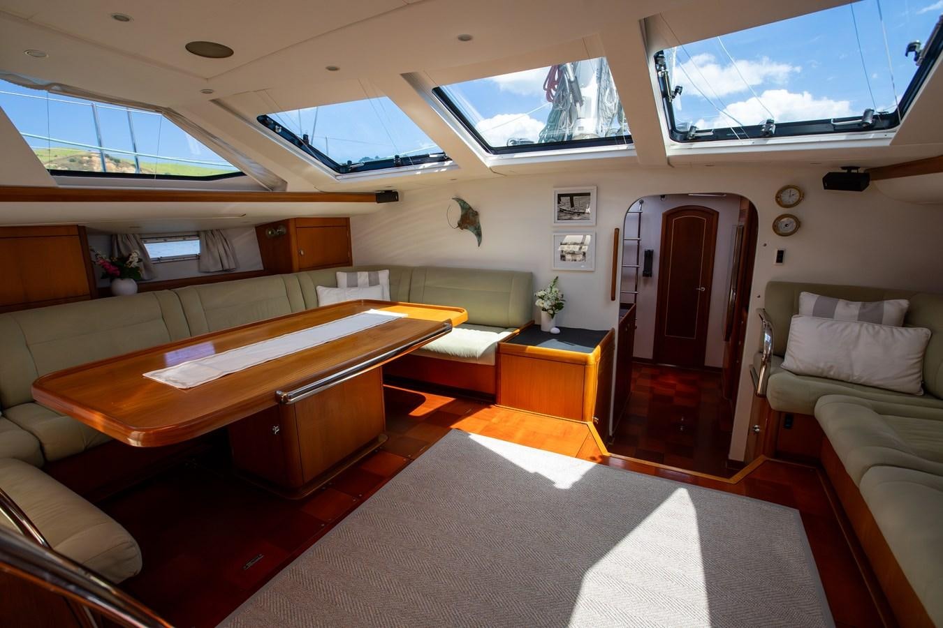 a room with a table and couch aboard CRAZY HORSE Yacht for Sale