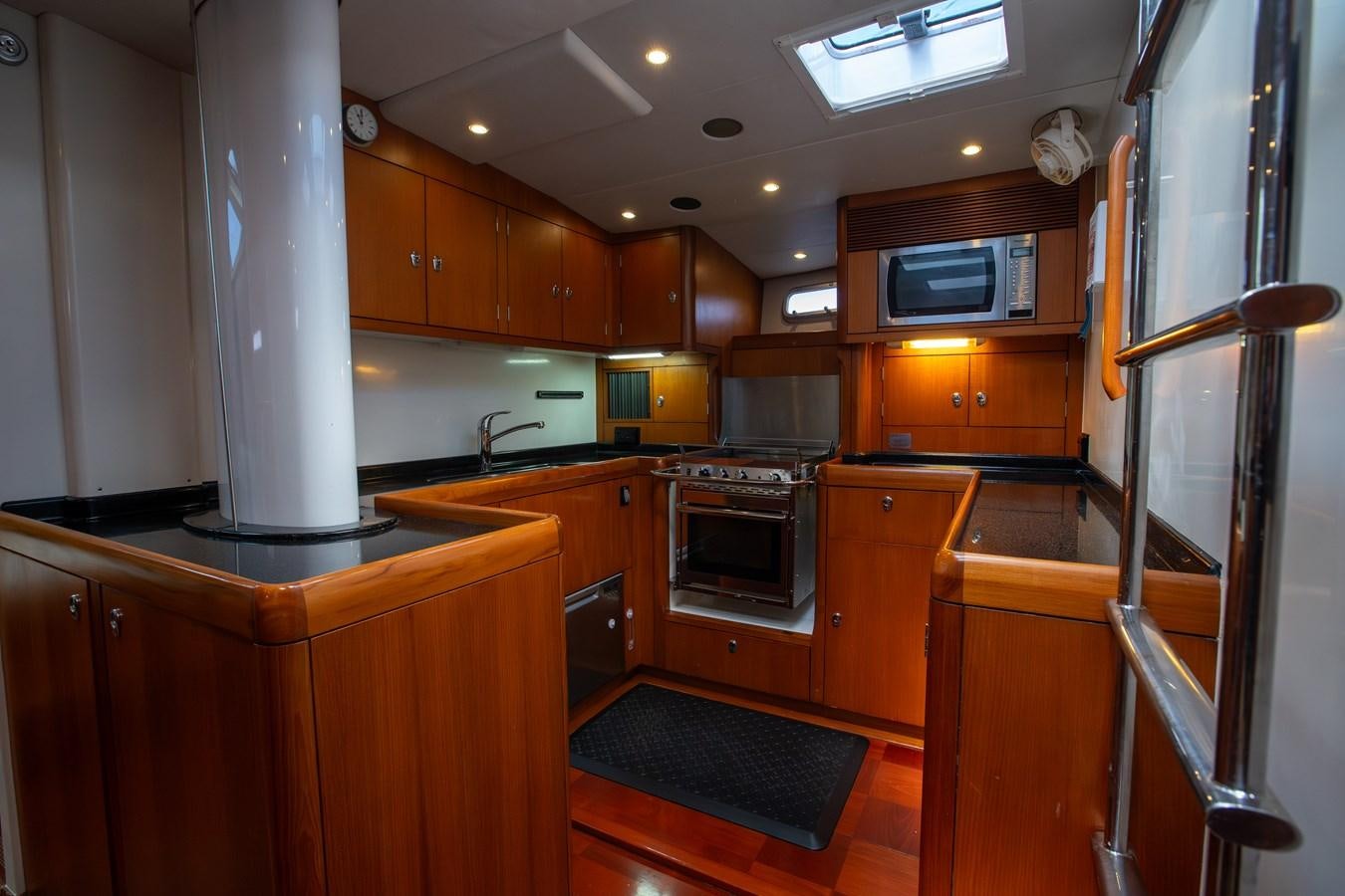 a kitchen with wooden cabinets aboard CRAZY HORSE Yacht for Sale