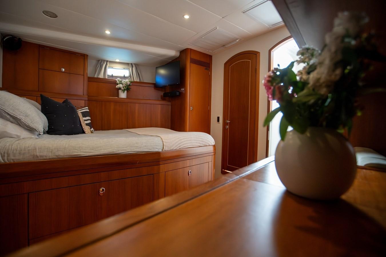 a room with a bed and a plant aboard CRAZY HORSE Yacht for Sale