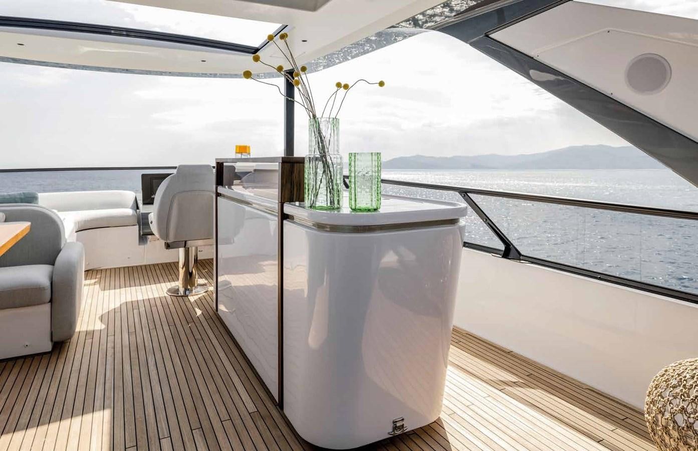 a glass vase with flowers on a table aboard AZIMUT 72 Yacht for Sale