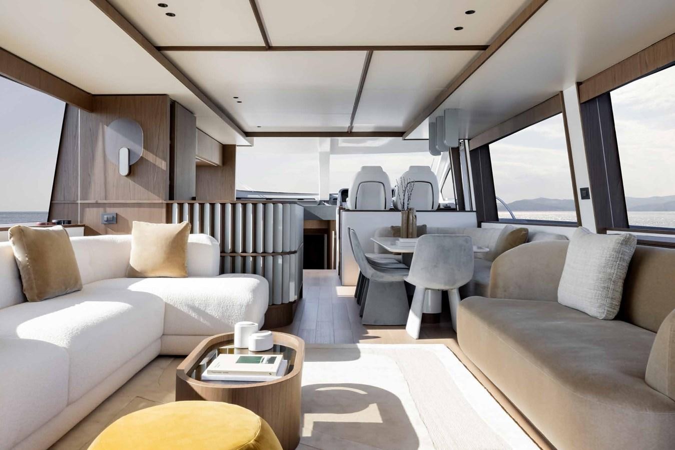 a room with a couch and a table aboard AZIMUT 72 Yacht for Sale