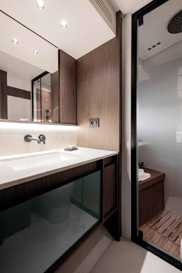 a bathroom with a sink and a mirror aboard AZIMUT 72 Yacht for Sale