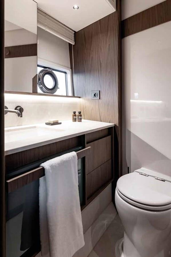 a bathroom with a sink toilet and a bathtub aboard AZIMUT 72 Yacht for Sale