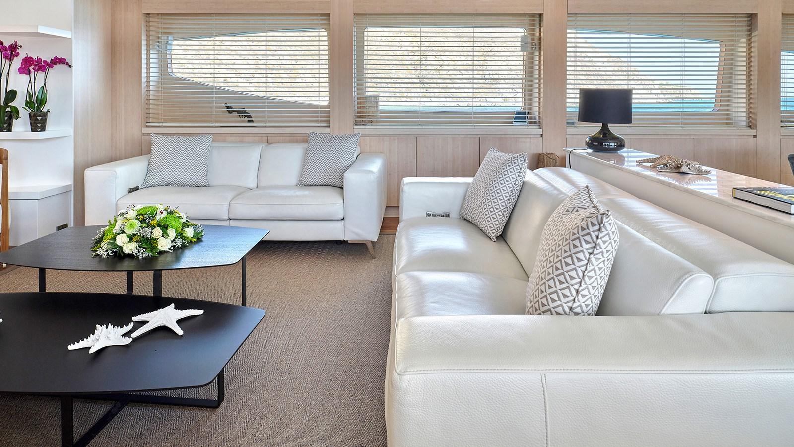 a living room with white couches aboard WHITE KNIGHT Yacht for Sale